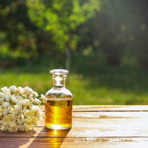 Aromatic essential oil and white flowers. Spa concept. Cosmetics and spa care. Copy space